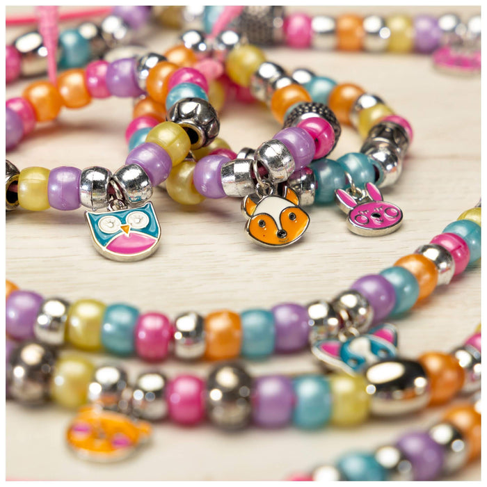 Colorful bead bracelets with silver-toned animal charms shaped like an owl, a fox, and a bunny.