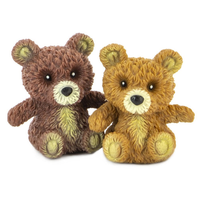 Two small, textured dark and light brown toy bears with cream-colored snouts and chest patches.