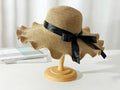 Women’s dark brown straw sun hat with wide brim, floppy derby style, perfect for summer beach outings and outdoor protection.