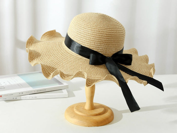 Dark brown women's wide brim floppy straw sun hat with derby style, perfect for summer beach and outdoor wear.