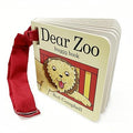 Small board book featuring a lion on the cover and a red fabric Velcro strap for attaching to a buggy.