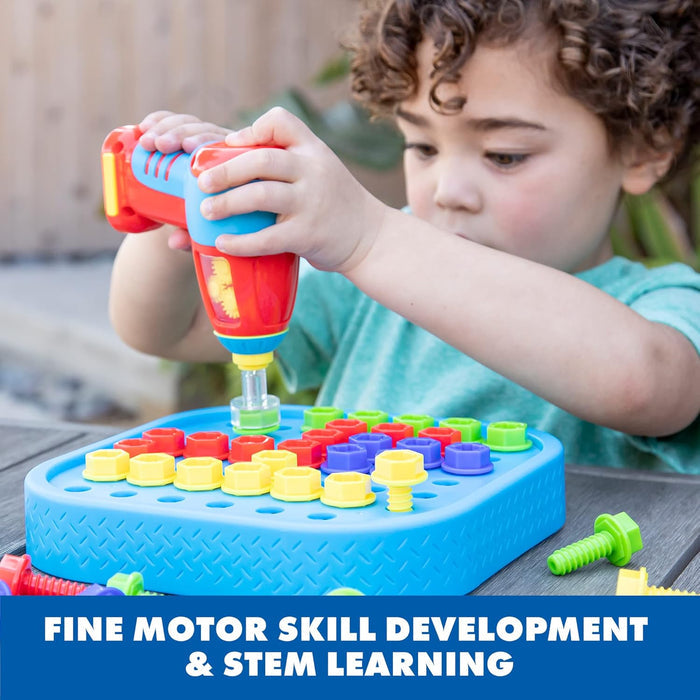 Child using a red and blue toy drill to screw colorful plastic bolts into a blue pegboard.