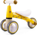 Yellow giraffe-patterned ride-on toy with brown spots, a white seat, and grey wheels with yellow trim.