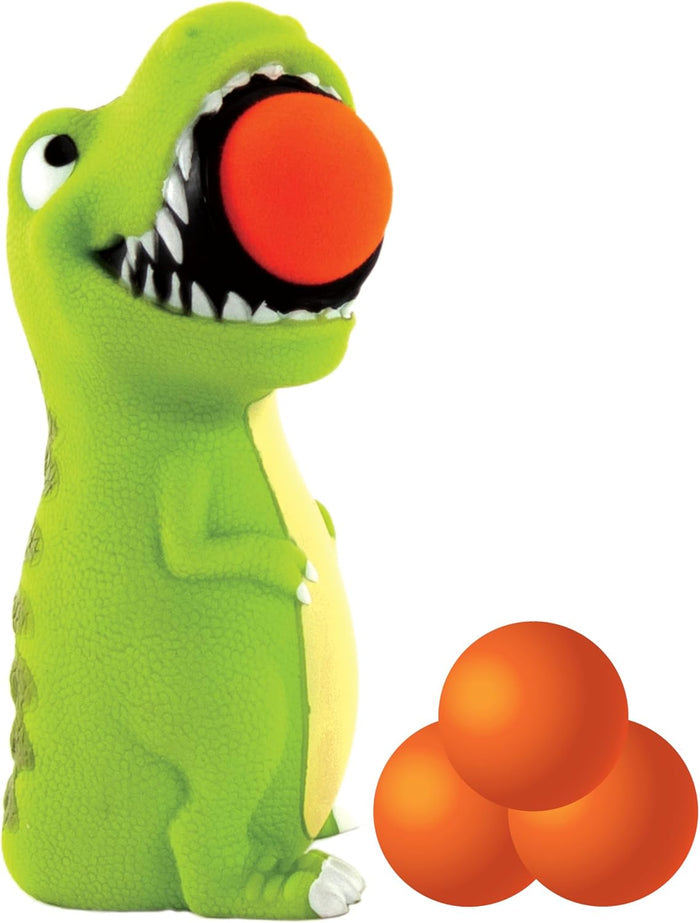 Green dinosaur toy with an orange foam ball in its open mouth and three extra orange balls on a white background.