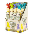 Display box of red, green, blue, and teal dinosaur toppers hatching from eggs on bubble wands.