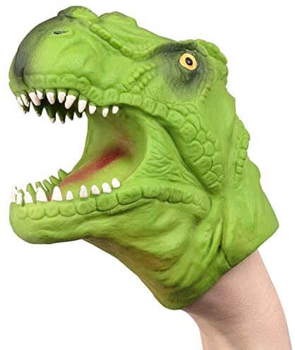 Textured green T-rex hand puppet with an open mouth, sharp white teeth, and yellow eye, worn on a person's wrist.