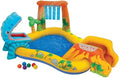 Colorful inflatable pool featuring a blue dinosaur hoop, volcano slide, water spray arch, and play balls.