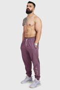 Fuaark Nz mauve oversized joggers made of soft, comfortable fabric, laid flat showing relaxed fit and stylish design.
