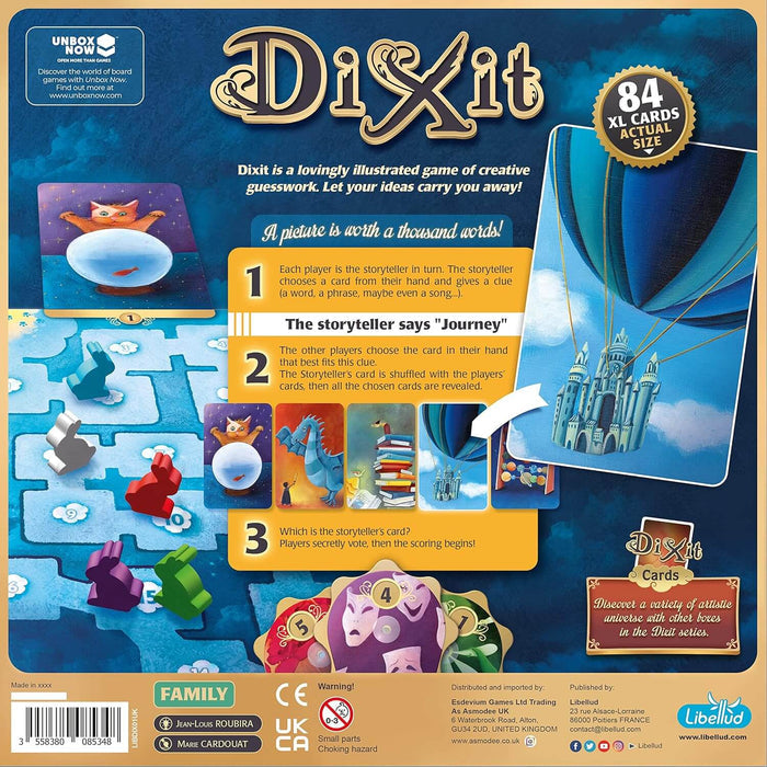 Back of a blue Dixit game box featuring colorful fantasy art cards, numbered gameplay steps, and a gold badge.