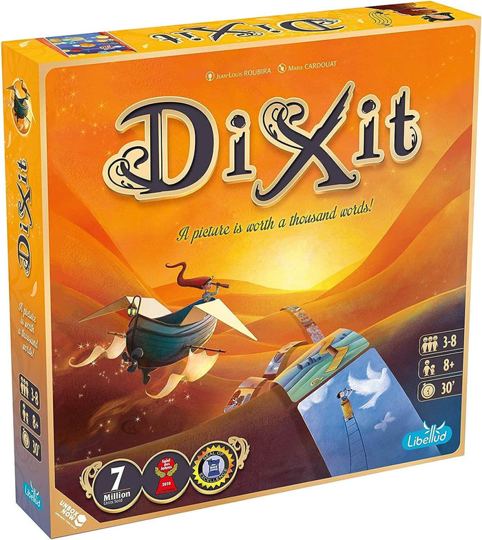Orange Dixit game box with whimsical art of a flying ship trailing cards over desert dunes under a golden sunset.