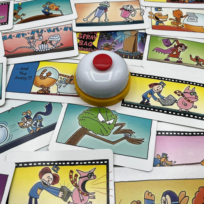 Colorful game cards with comic book illustrations scattered around a white game bell with a red button.