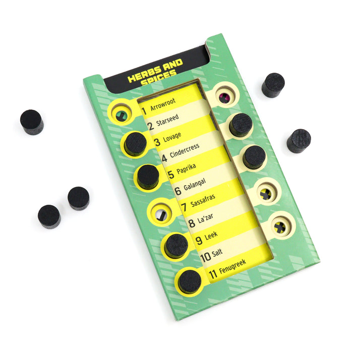 Green and yellow game card listing eleven herbs and spices with black wooden pegs in circular holes.
