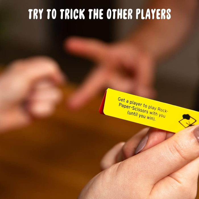 Hand holds a yellow secret mission slip while people play Rock-Paper-Scissors in the blurred background.