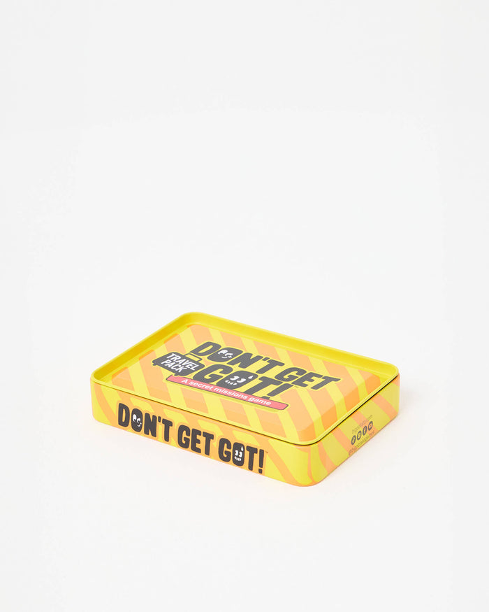 Yellow and orange striped rectangular metal tin with bold black text reading Don't Get Got! A secret missions game.