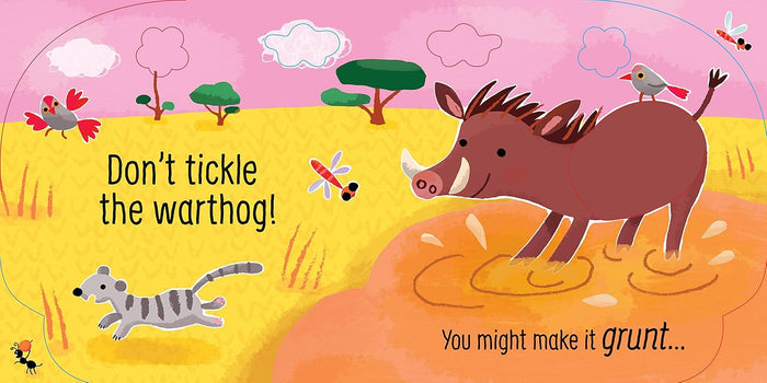 Colorful book page showing a brown warthog splashing in mud against a pink and yellow savannah background.