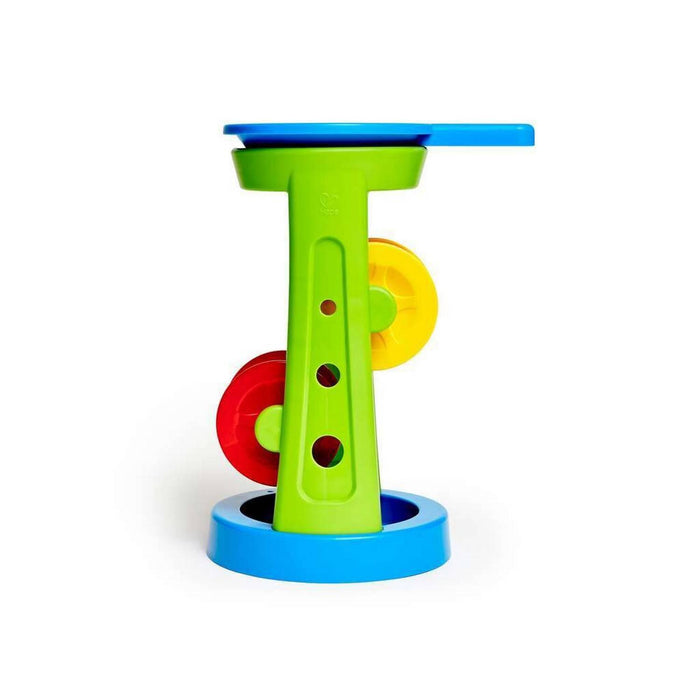 Green plastic tower toy with red and yellow spinning wheels, a blue funnel top, and a blue circular base.