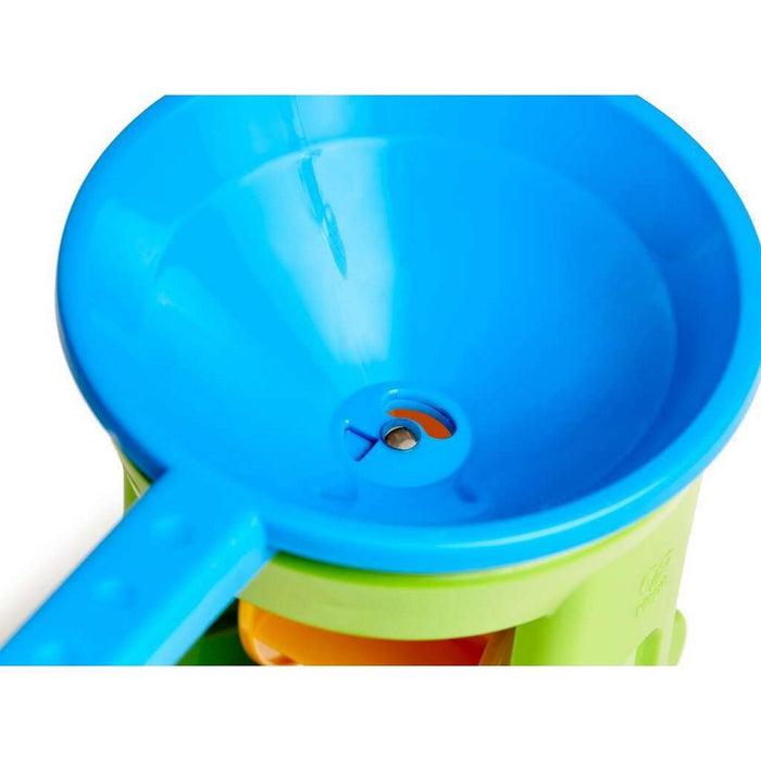 Close-up view of the bright blue funnel top and green base of a plastic sand and water wheel toy.