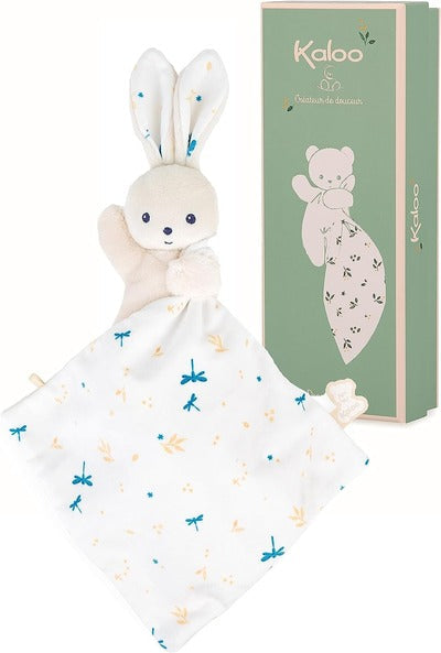 Cream plush rabbit attached to a blue dragonfly print blanket, shown next to a tall sage green Kaloo gift box.