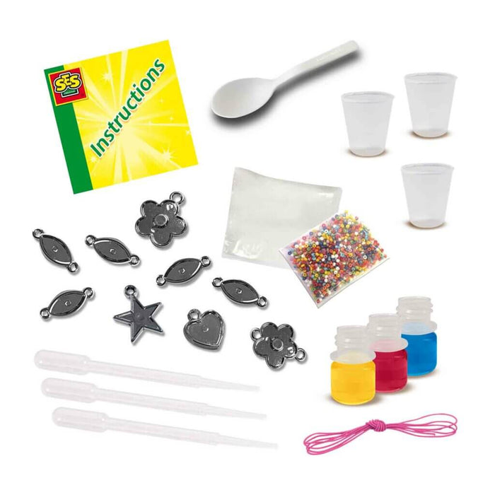 Bracelet craft kit with instructions, beads, dyes, pipettes, pink cord, and silver star, heart, and flower charms.