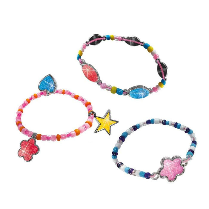 Three colorful beaded bracelets with sparkly glitter charms in heart, flower, star, and oval shapes.