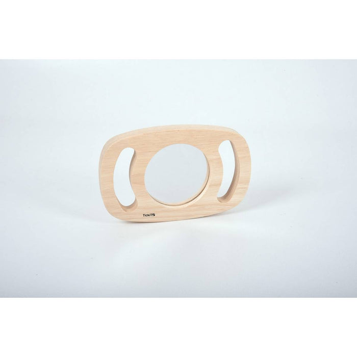 Oval light wood mirror with side handle cutouts and a circular reflective center on a plain white background.