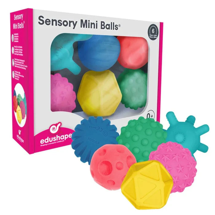 Six colorful sensory balls with various textures like bumps and spikes, shown inside and outside their product box.