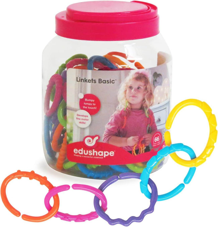 Clear jar of colorful textured rings with a pink lid. Five connected links in various colors in the foreground.