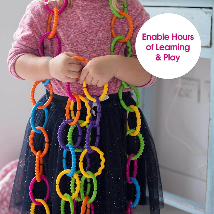 Child wearing a long chain of colorful, bumpy plastic rings in bright shades of orange, yellow, green, and blue.