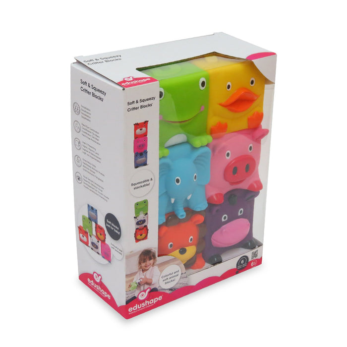 Box displaying six colorful, square animal blocks: green frog, yellow duck, blue elephant, pink pig, lion, and cow.