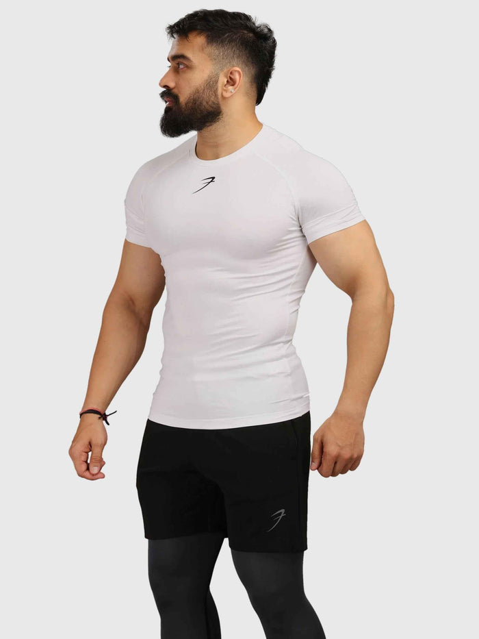 White Fuaark Nz performance compression T-shirt for athletic wear, designed to elevate your game and provide comfortable fit.
