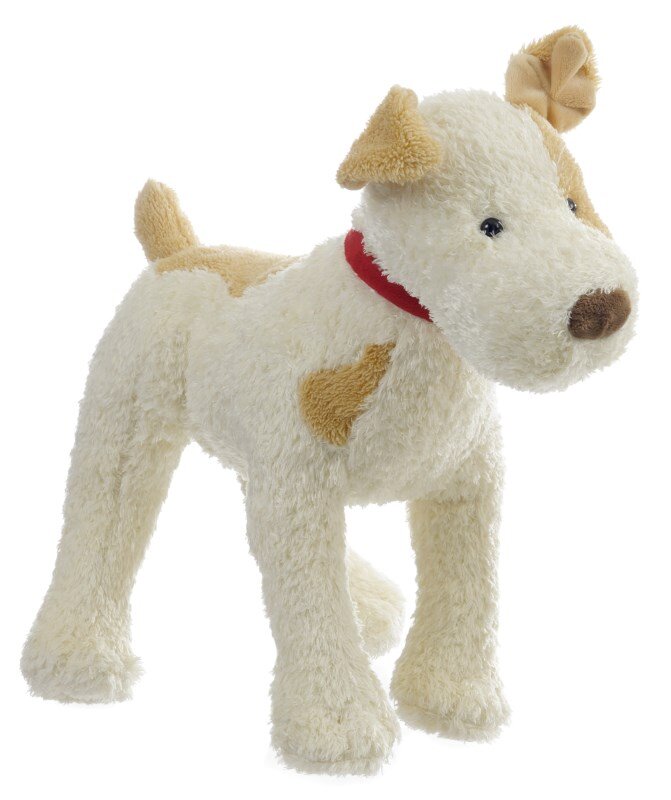 Cream plush dog with tan patches on its ear, eye, and body, wearing a red collar and standing on all fours.