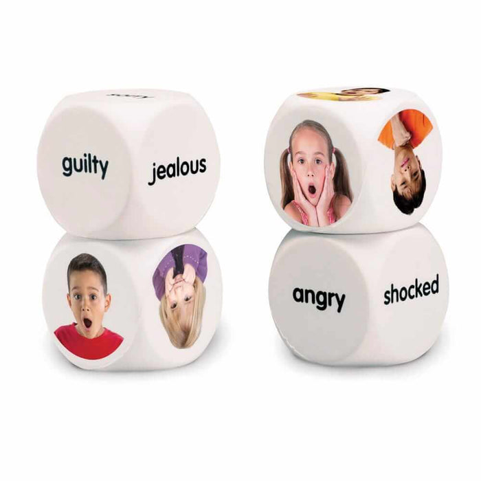 Four white dice featuring photos of children's facial expressions and emotion words like angry, shocked, and jealous.