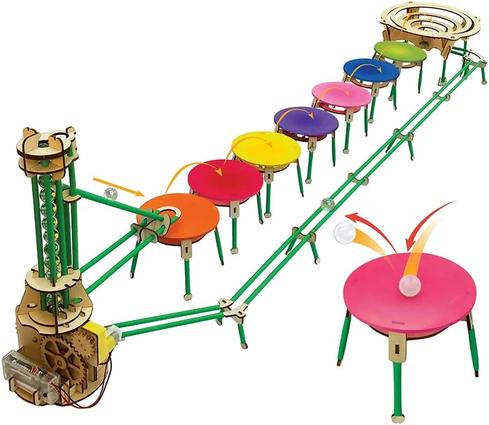 Motorized wooden marble run with a spiral lift, green rails, and seven colorful pads for bouncing marbles.