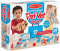 Toy packaging showing kids playing with plush pets and 24 medical accessories like a stethoscope and blue carry bag.