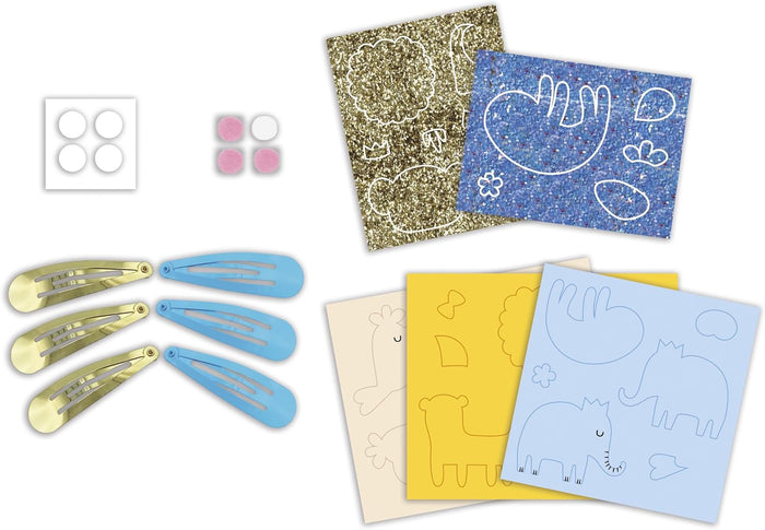 Six gold and light blue hair clips with glittery animal-shaped sheets, colored paper, and adhesive pads for DIY crafts.