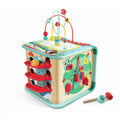 Teal and wood activity cube with a bead maze, ball ramps, and forest scene. Includes a small toy mallet.