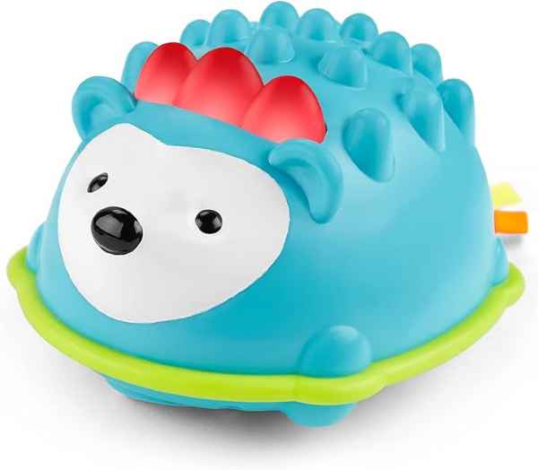 Blue dome-shaped hedgehog toy with three red spines, black facial features on a white face, and a lime green base.