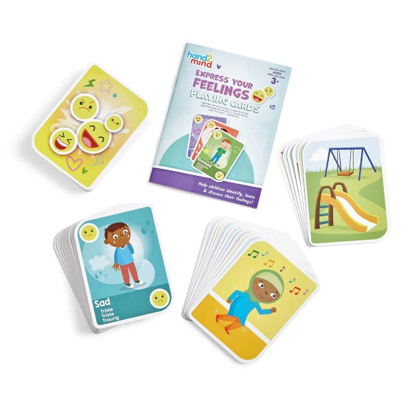 Instruction booklet and colorful card decks showing diverse children and emojis expressing feelings like sad and happy.