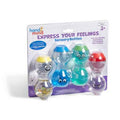 Four colorful hourglass-shaped sensory bottles with expressive faces inside clear retail packaging.