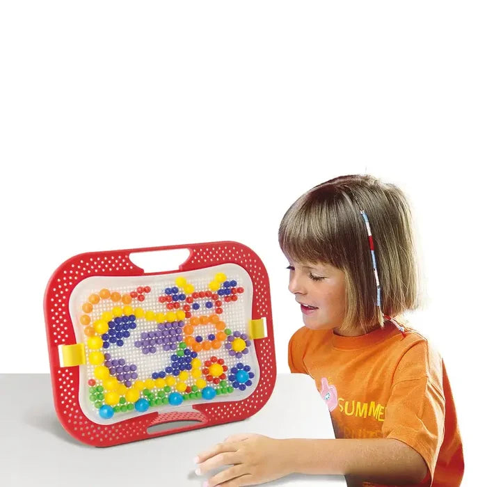 Young girl looks at a red-framed peg board filled with colorful pegs arranged in mosaic animal and flower designs.
