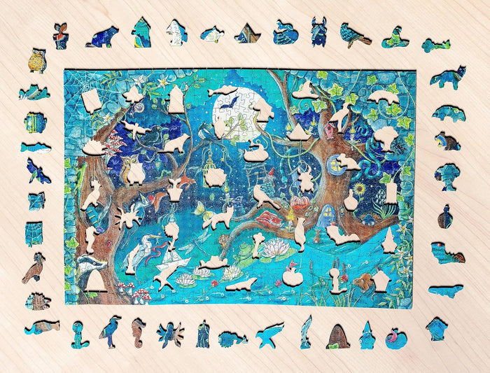 Wooden puzzle of a blue moonlit forest with animal-shaped pieces surrounding and overlaying the whimsical scene.