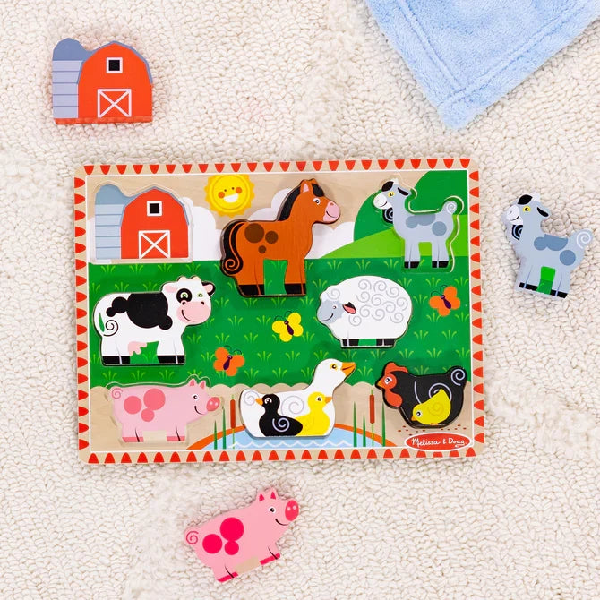 Colorful 8-piece wooden farm animal chunky puzzle with thick cow, pig, and barn pieces on a textured rug.