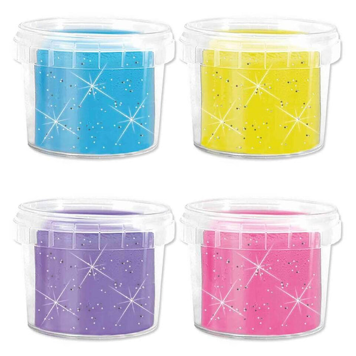 Four clear plastic tubs of sparkly blue, yellow, purple, and pink dough with glitter and starburst designs.