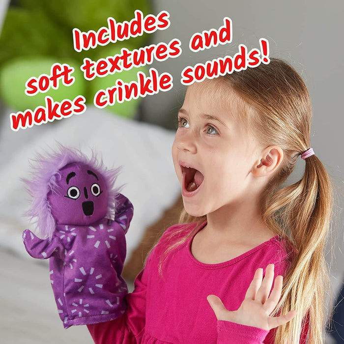 Excited girl holding a purple hand puppet with messy hair and a shocked expression.