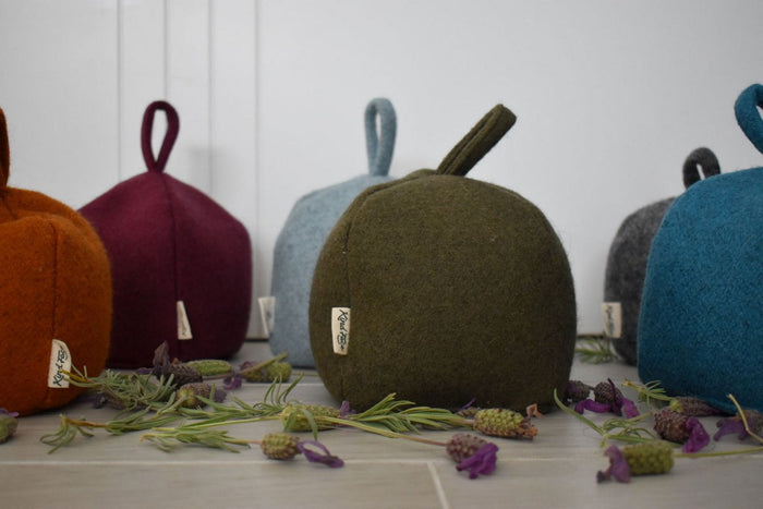 Felted New Zealand wool door stop by Do Not Disturb Sleep Company, soft textured and shaped to hold doors open securely.