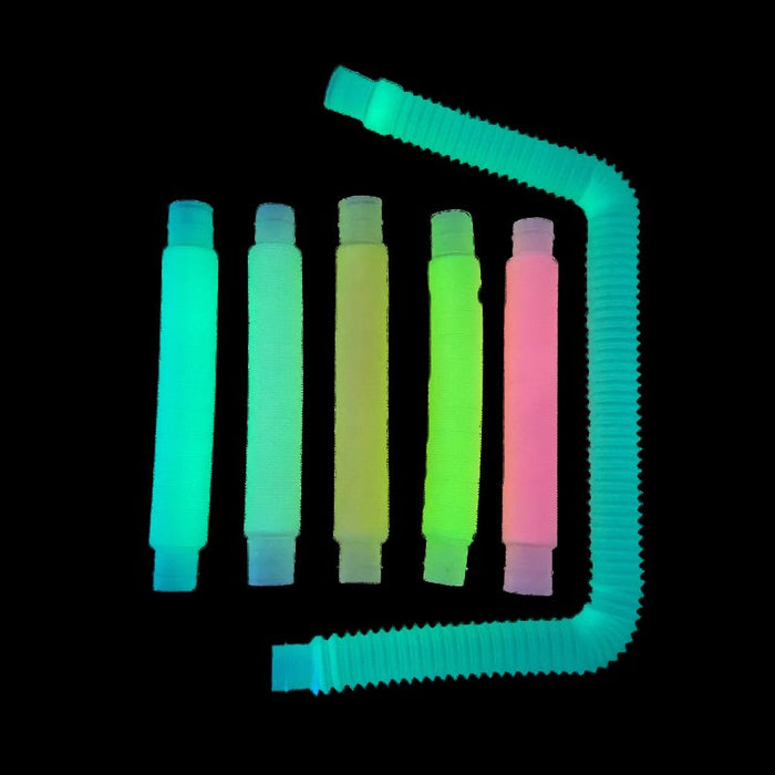 Six glowing neon-colored ribbed tubes. One is stretched in a U-shape around five collapsed upright tubes.