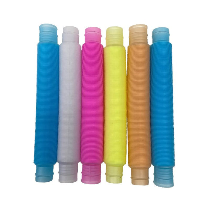 Six colorful corrugated plastic tubes in blue, white, pink, yellow, and orange standing vertically in a row.
