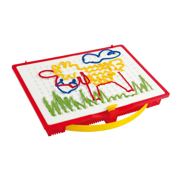 White pegboard with red frame and yellow handle, featuring a sheep and grass made from colorful strings.