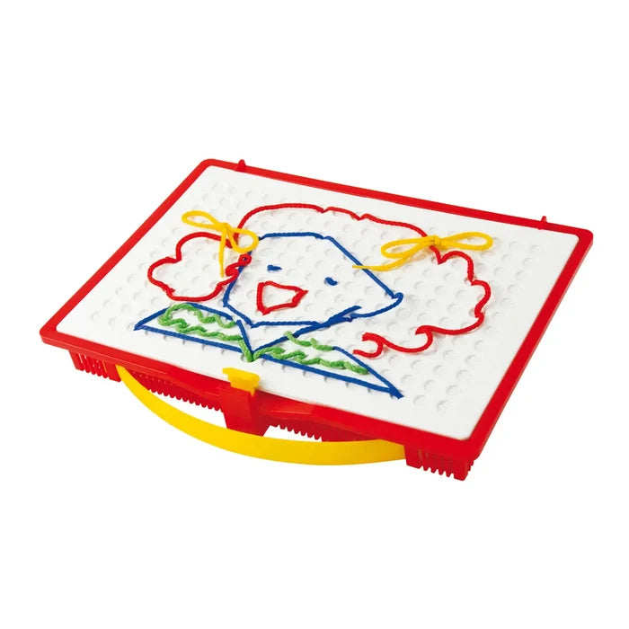 White pegboard in a red frame featuring a smiling face design made of colorful threaded laces.