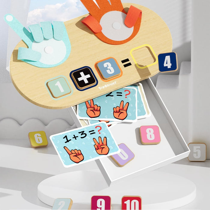 Wooden board with felt counting hands, number tiles showing 1 plus 3 equals 4, and illustrated math flashcards.